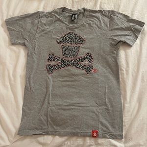 Johnny Cupcakes Cement Crossbones Logo